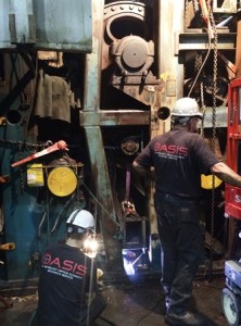 OASIS technicians remove framework in dryer can section at American Eagle Paper Mills. 